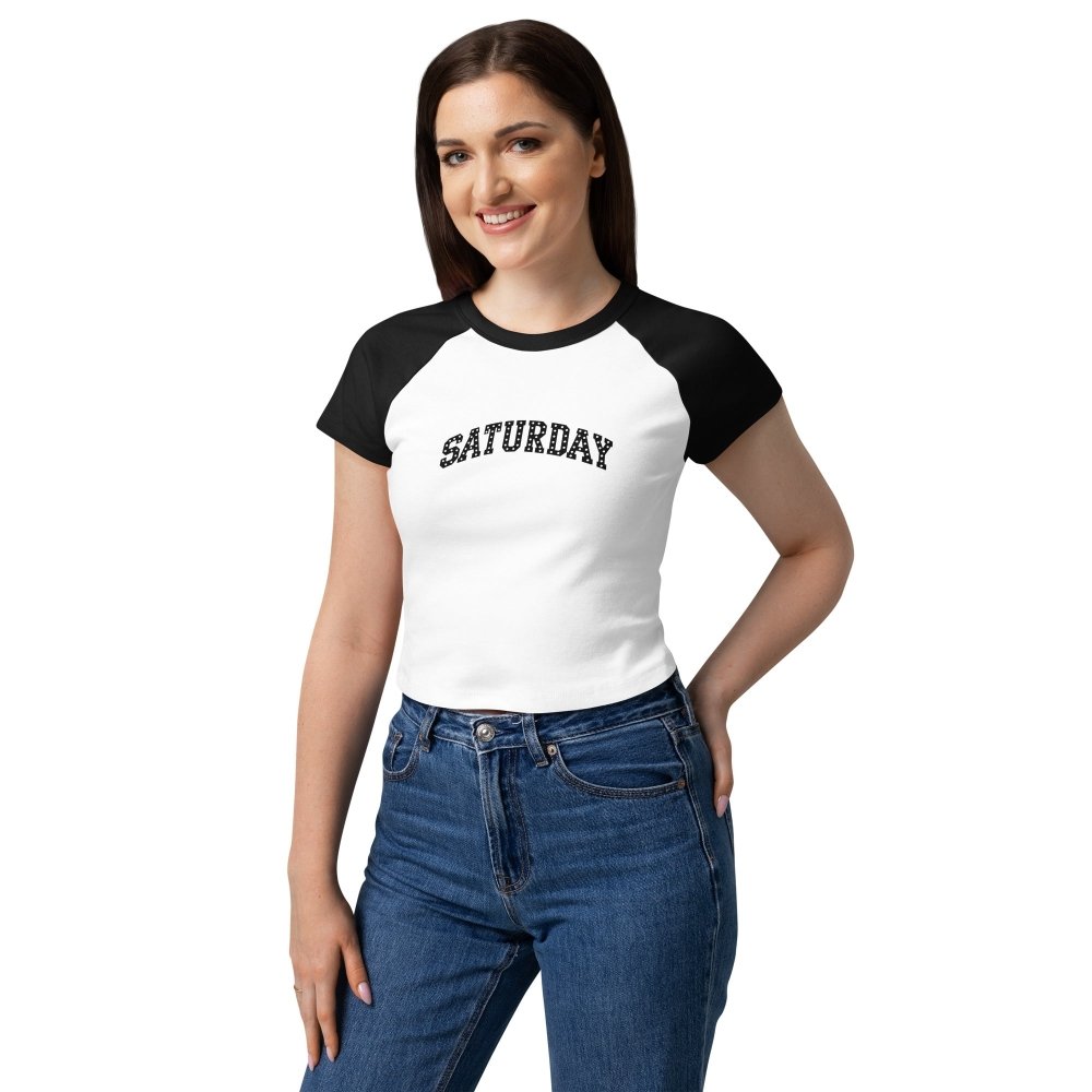 Model wearing a white and black HAGS Saturday polka-dot raglan baby tee.