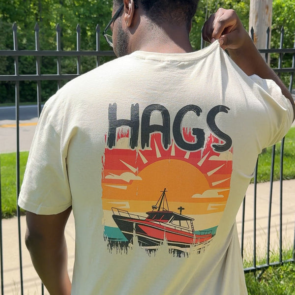 Person wearing a t-shirt with a graphic design on the back outdoors.