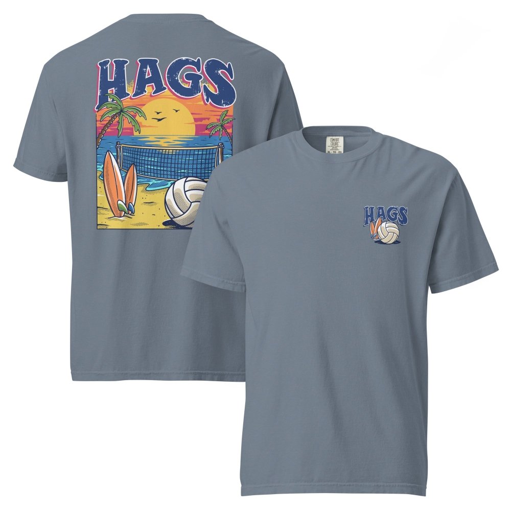 Front and back views of blue gray HAGS beach volleyball sunset T-shirt, showing small HAGS volleyball chest logo and a volleyball, surfboards and beach sunset graphic.