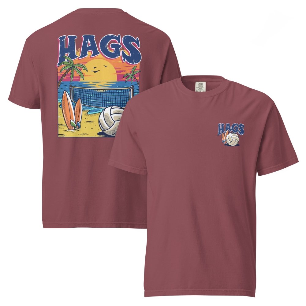 Front and back views of brick red HAGS beach volleyball sunset T-shirt, showing small HAGS volleyball chest logo and a volleyball, surfboards and beach sunset graphic.