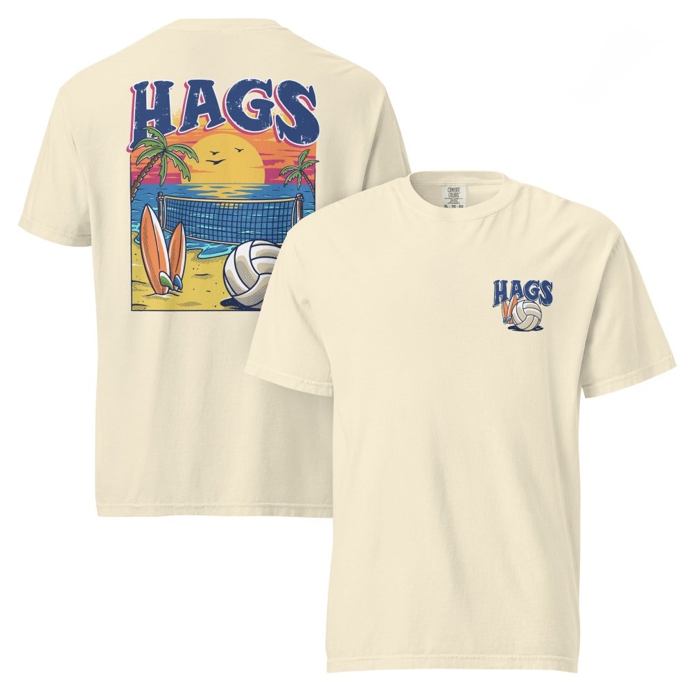 Front and back views of ivory HAGS beach volleyball sunset T-shirt, showing small HAGS volleyball chest logo and a volleyball, surfboards and beach sunset graphic.