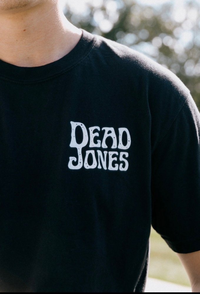 Close-up of white Dead Jones chest lettering on the black HAGS band T-shirt.