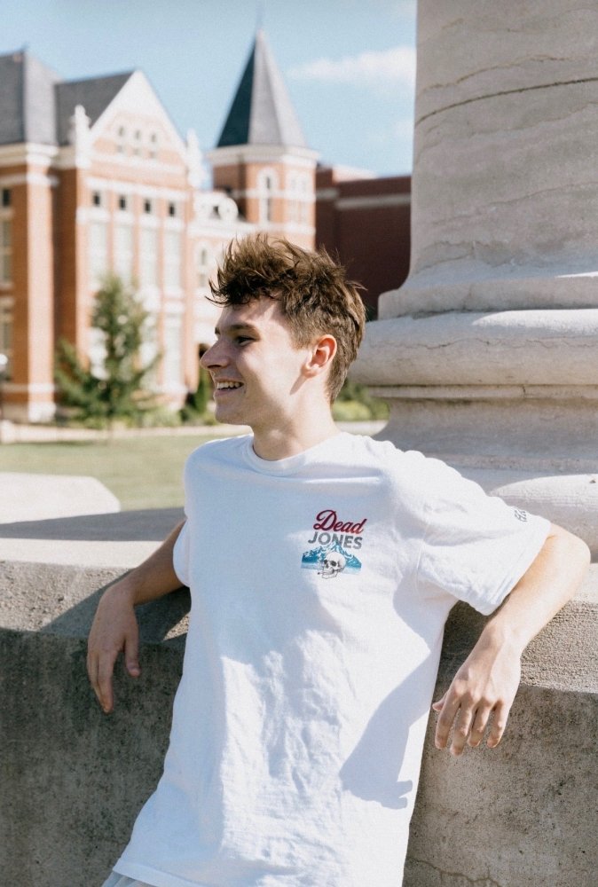 Man wearing the white HAGS Dead Jones Band vintage beer T-shirt outdoors.