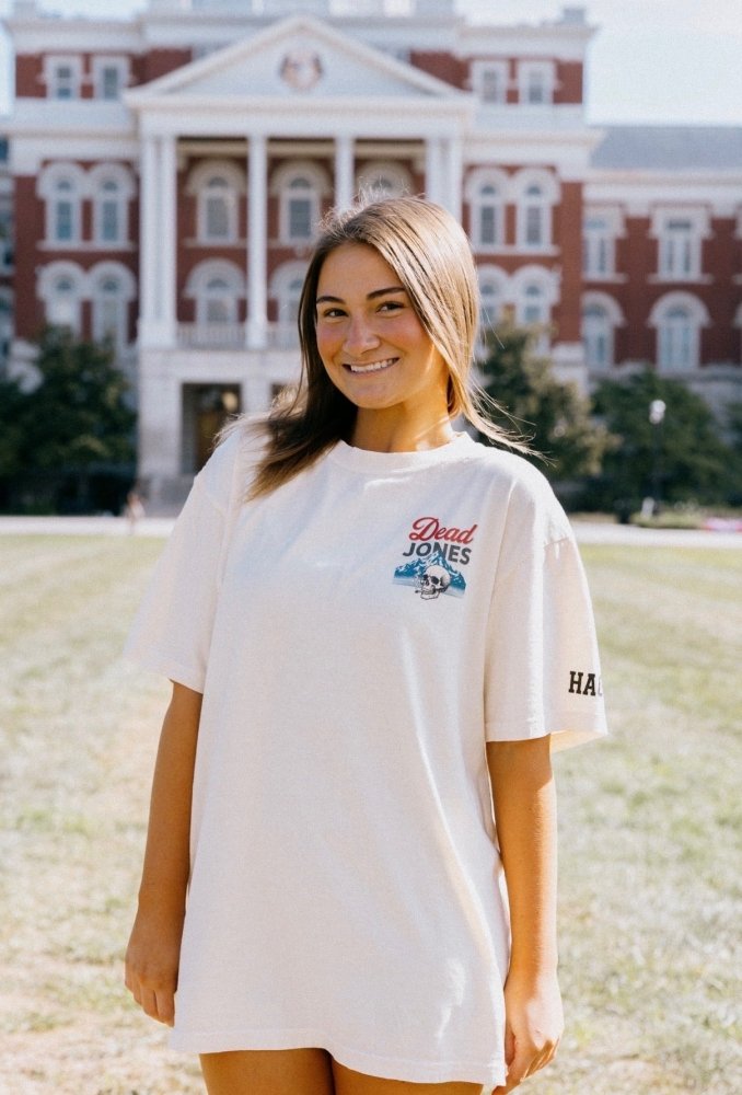 Woman wearing the white HAGS Dead Jones Band vintage beer T-shirt outdoors.