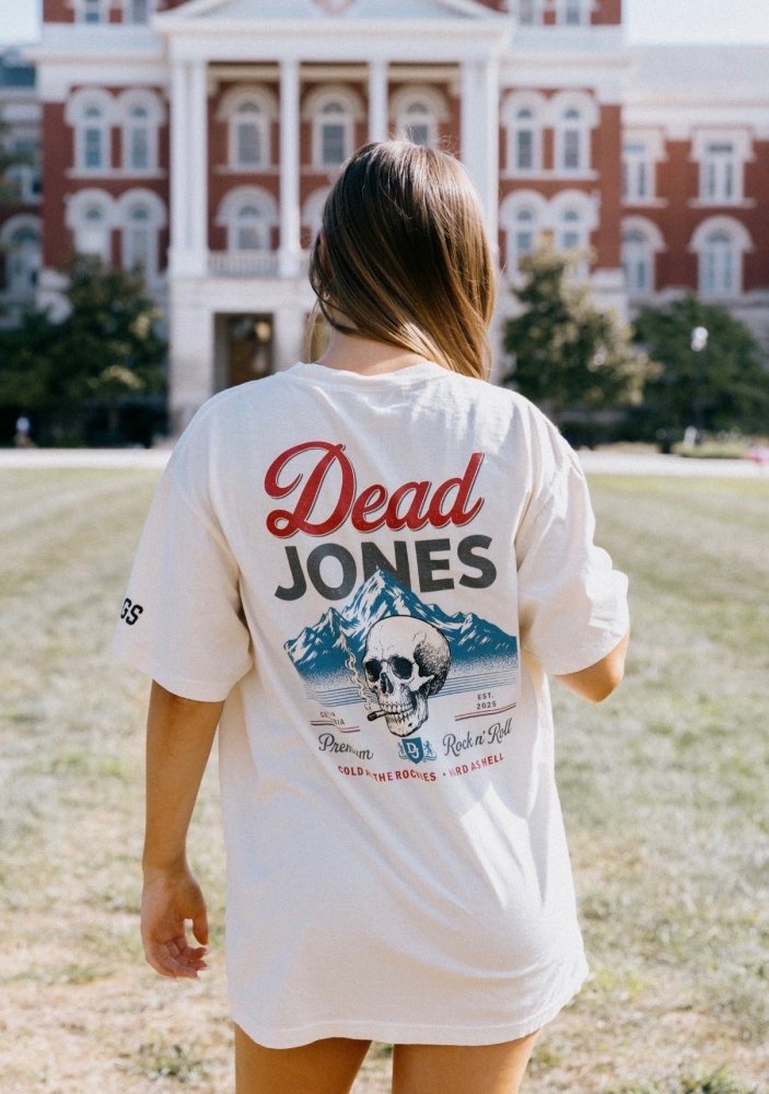 Woman wearing the white HAGS Dead Jones Band vintage beer T-shirt, showing the large skull and mountain back graphic.