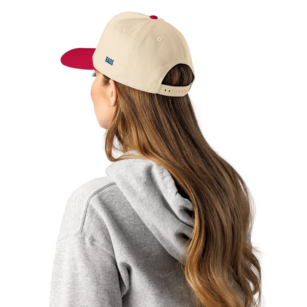 Model wearing a cream and red HAGS Have a Great Summer American flag snapback, viewed from behind.