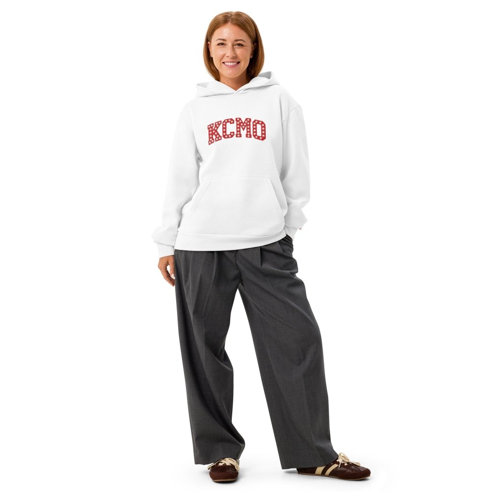 Model wearing a white HAGS KCMO Kansas City hoodie with red polka-dot lettering.
