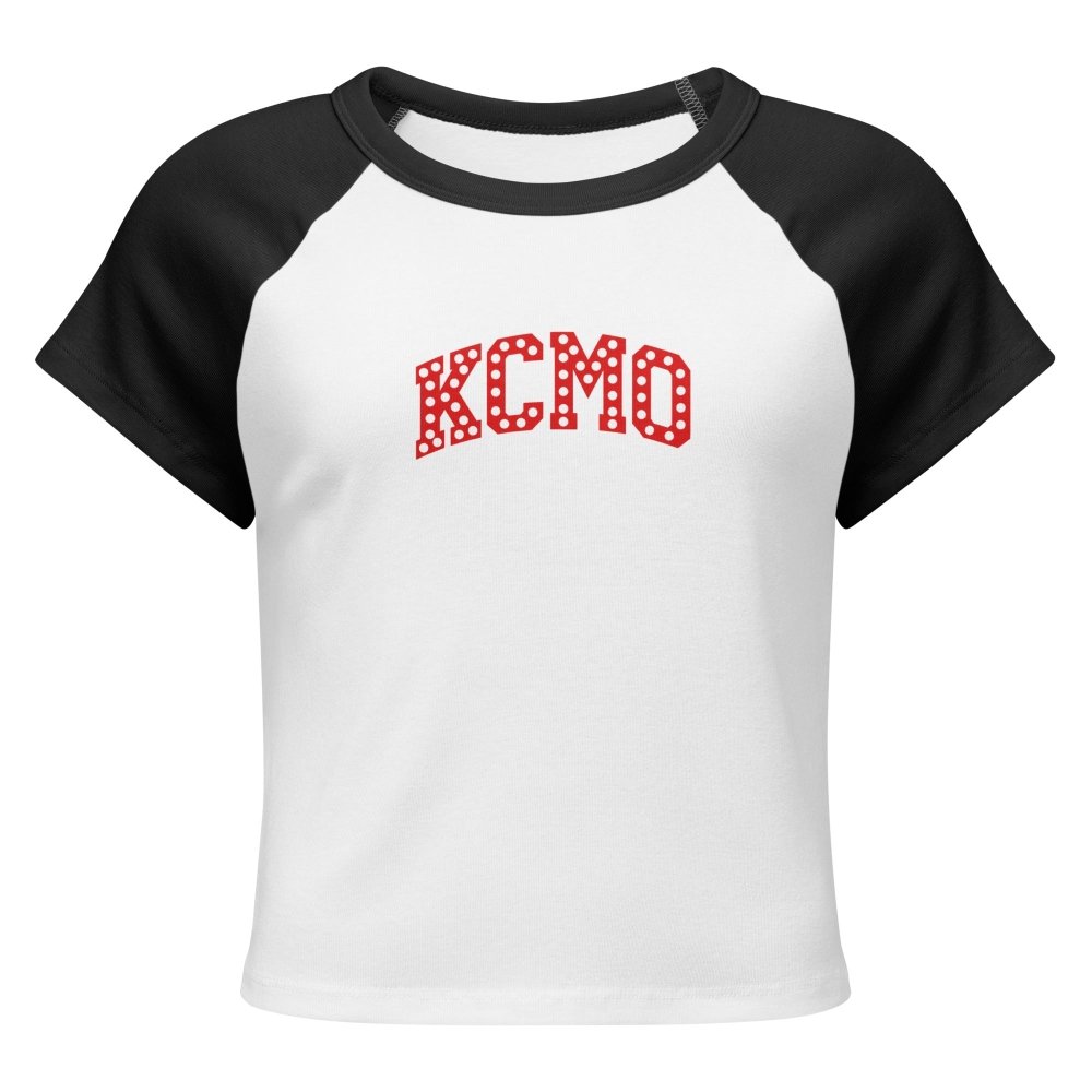 Front view of white and black HAGS KCMO polka dot raglan baby tee, showing red polka-dot KCMO lettering.