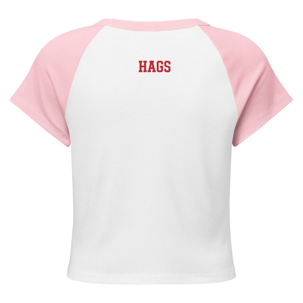 Back view of white and pink HAGS KCMO polka dot raglan baby tee, showing small red HAGS lettering below the collar.