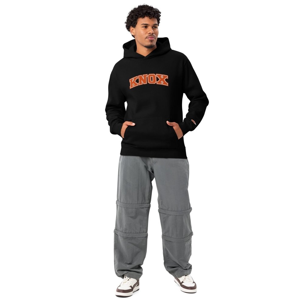 Model wearing a black HAGS Knox Tennessee hoodie with orange chest lettering.