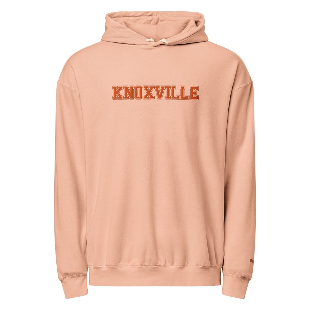 Front view of peach HAGS Knoxville Tennessee embroidered hoodie, showing orange KNOXVILLE chest lettering.