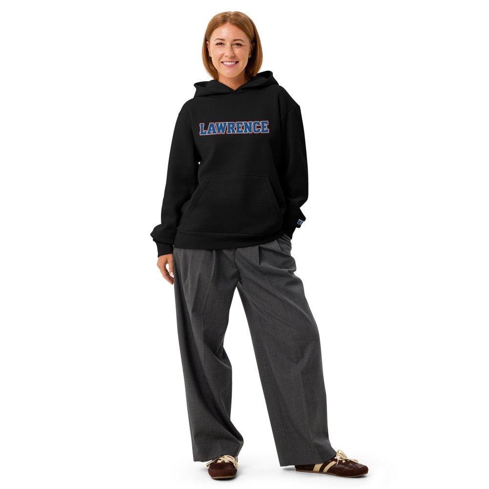 Model wearing a black HAGS Lawrence Kansas hoodie with blue LAWRENCE chest lettering.