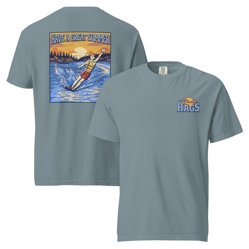 Front and back views of muted blue HAGS mens waterskiing T-shirt, showing small HAGS chest graphic and a waterskier and sunset graphic.