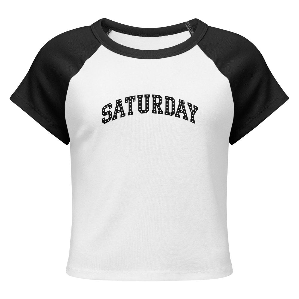Front view of white and black HAGS Saturday polka dot raglan baby tee, showing black polka-dot SATURDAY lettering.