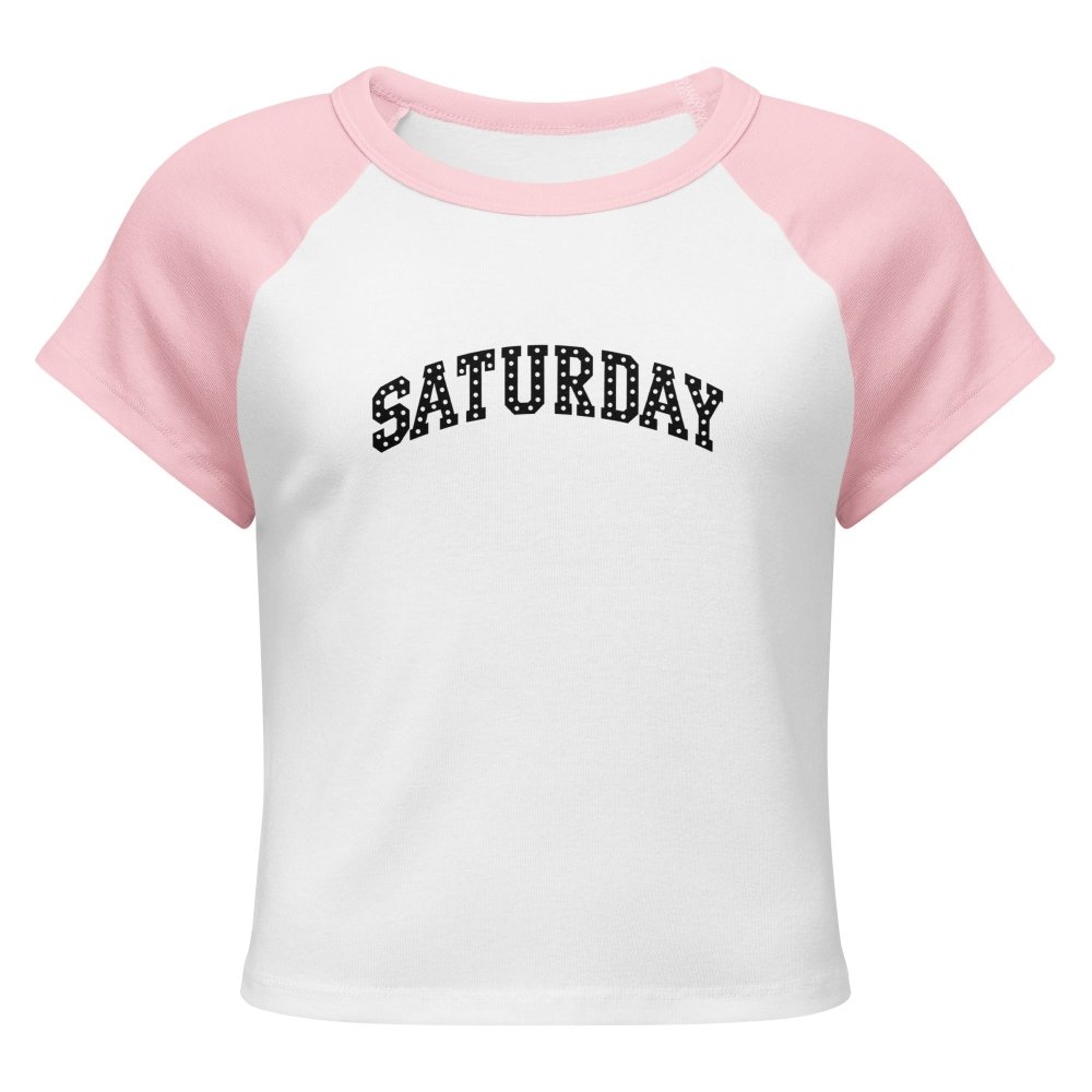 Front view of white and pink HAGS Saturday polka dot raglan baby tee, showing black polka-dot SATURDAY lettering.
