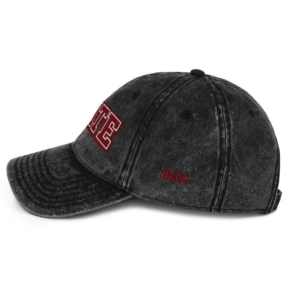 Angled front view of washed black HAGS State washed dad hat, showing maroon and white STATE embroidery.