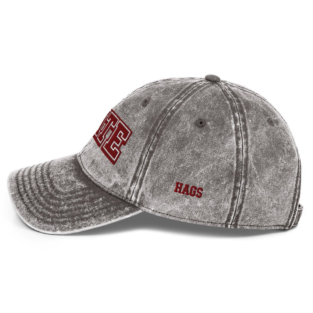 Angled front view of washed gray HAGS State washed dad hat, showing maroon and white STATE embroidery.