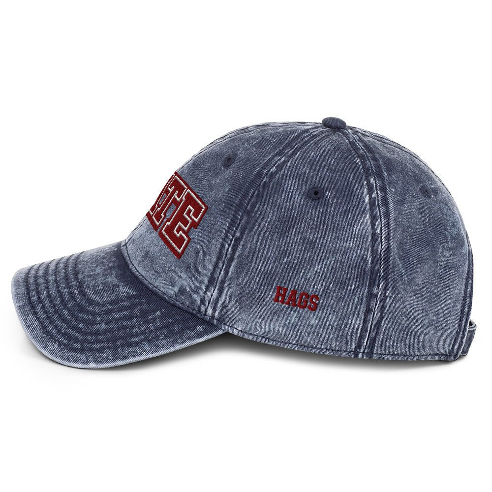 Angled front view of washed navy HAGS State washed dad hat, showing maroon and white STATE embroidery.