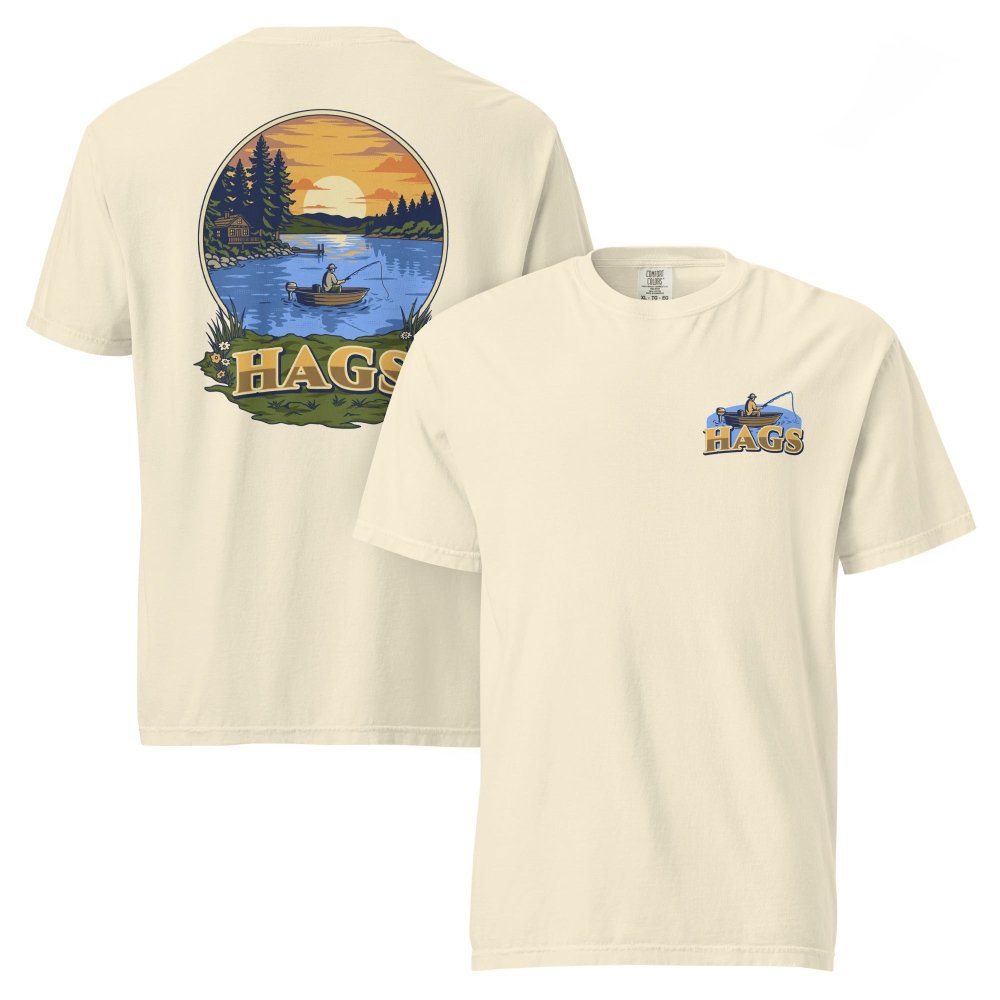 Front and back views of ivory HAGS sunset fishing T-shirt, showing small HAGS fishing chest graphic and a sunset lake fishing illustration.